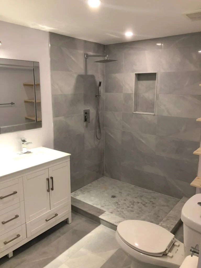 Raakss Reno Kitchen, Basement, and Bathroom Renovations in the Greater Toronto Area - Bathroom Renovation with glass shower door and tiling