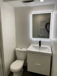 Modern Toronto bathroom with smart mirror, floating vanity, and integrated LED lighting mirror