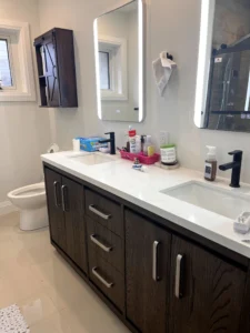 Smart bathroom mirror showing weather, time, and lighting settings on touchscreen interface