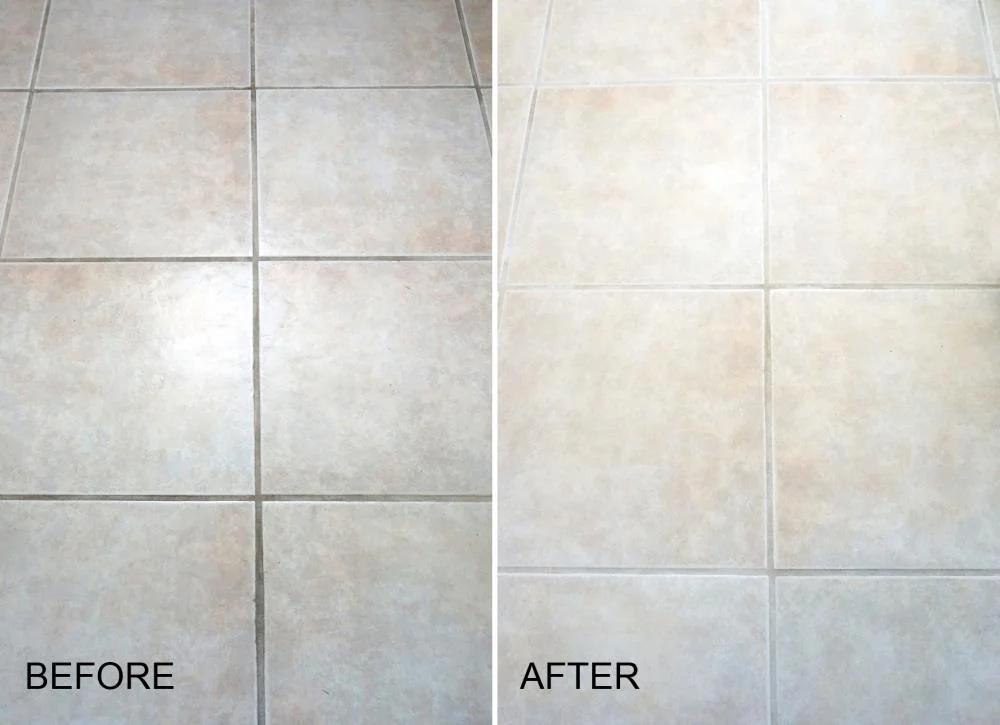 Cleaning bathroom tiles with vinegar spray to remove mold