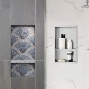 Comparison of a custom tiled shower niche with decorative mosaic pattern beside a finished stainless steel shower niche with shelves holding toiletries.