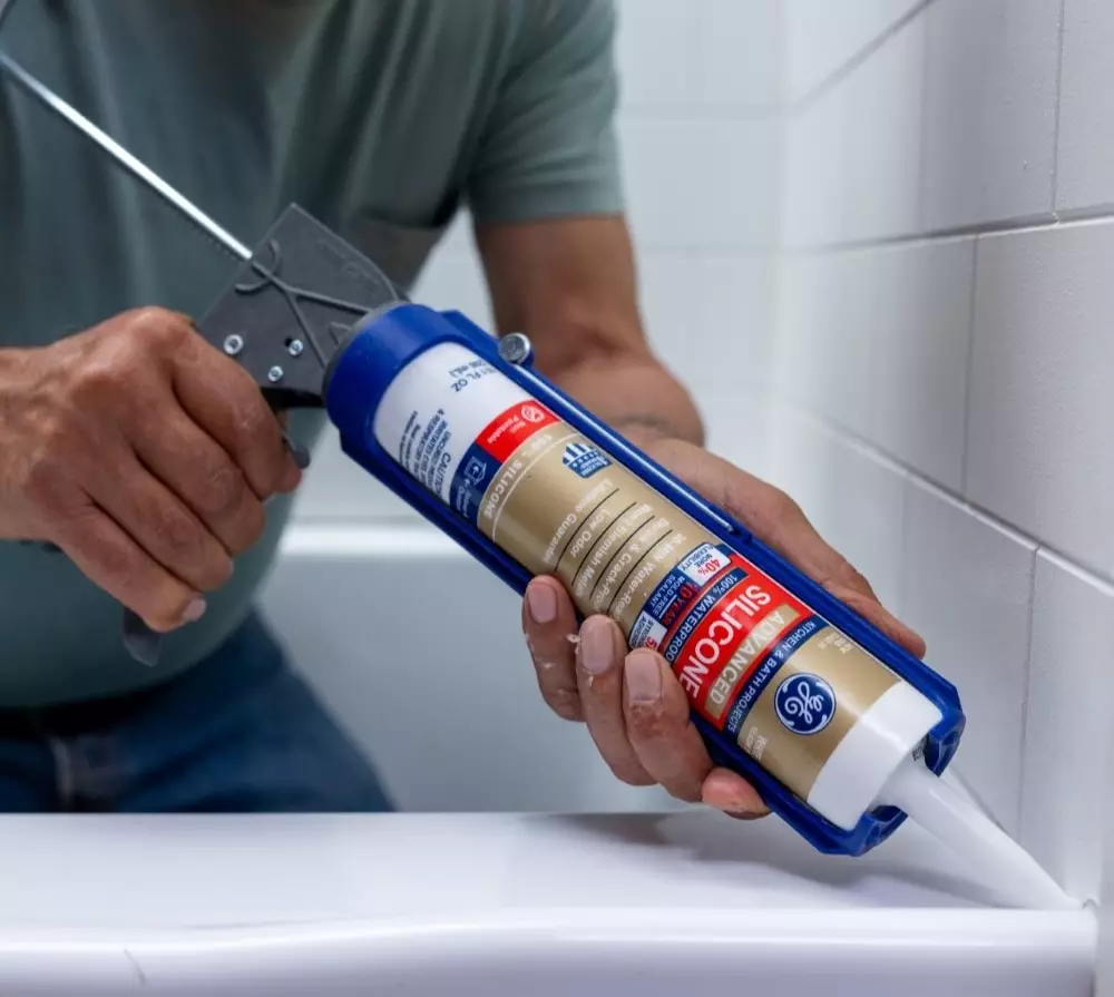 Resealing bathroom caulk to prevent water seepage and mold